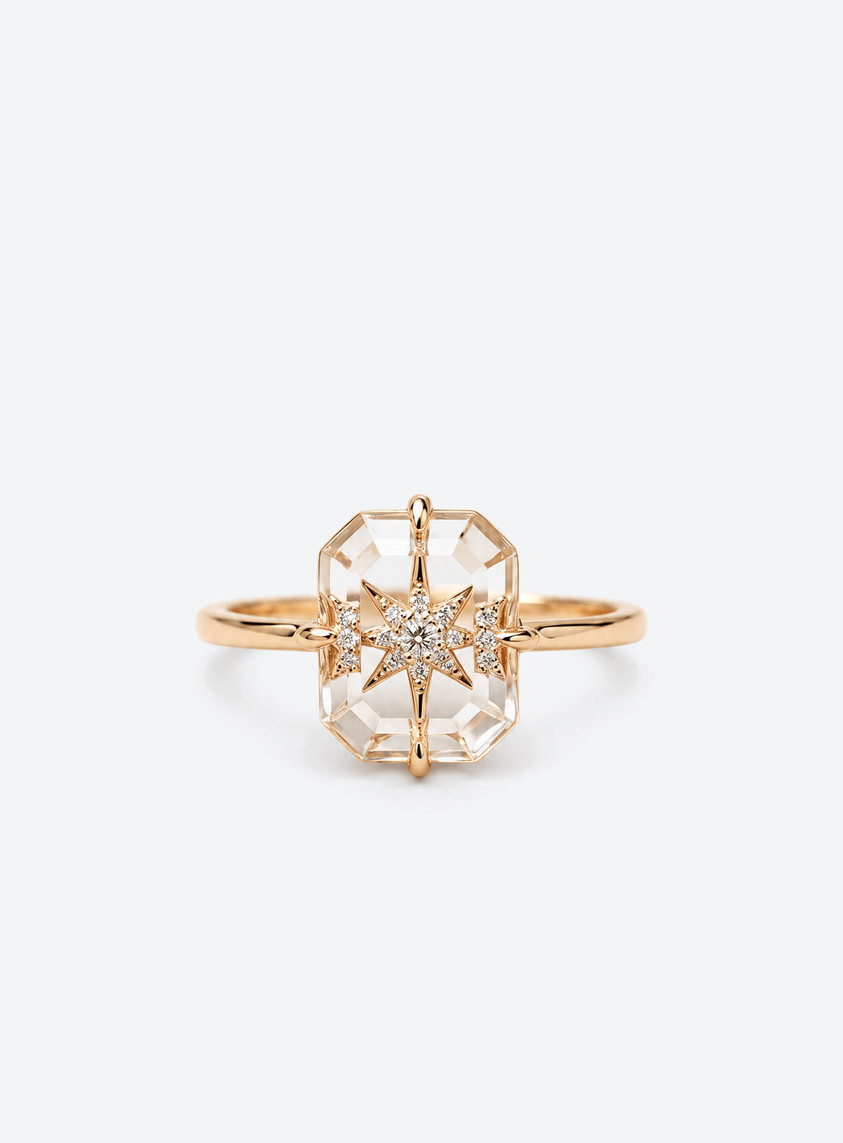 Slim silver or gold ring with clear rectangular centre, starburst motif and small clear accents