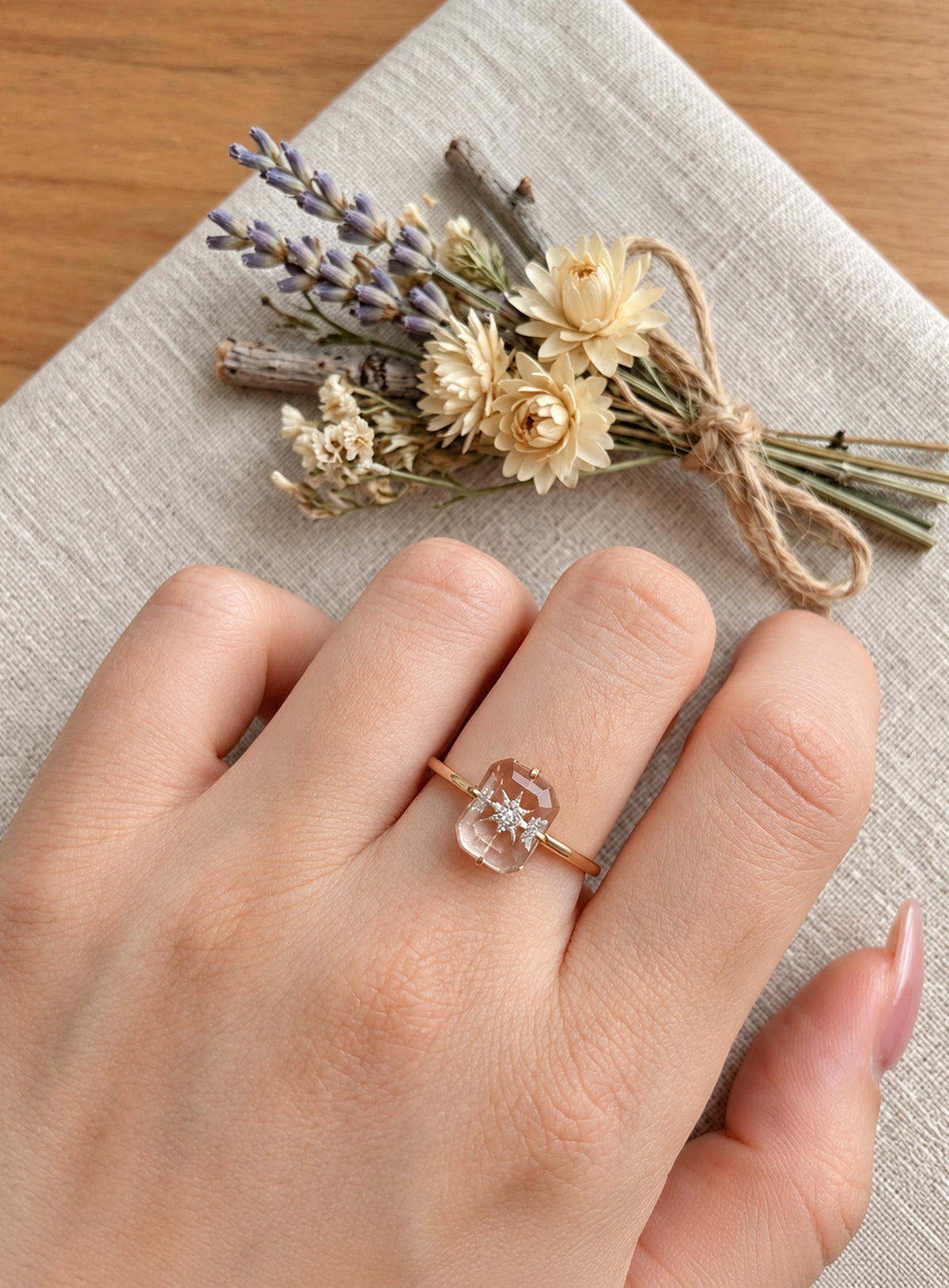 Slim silver or gold ring with clear rectangular centre, starburst motif and small clear accents