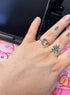 Slim silver or gold ring with clear rectangular centre, starburst motif and small clear accents