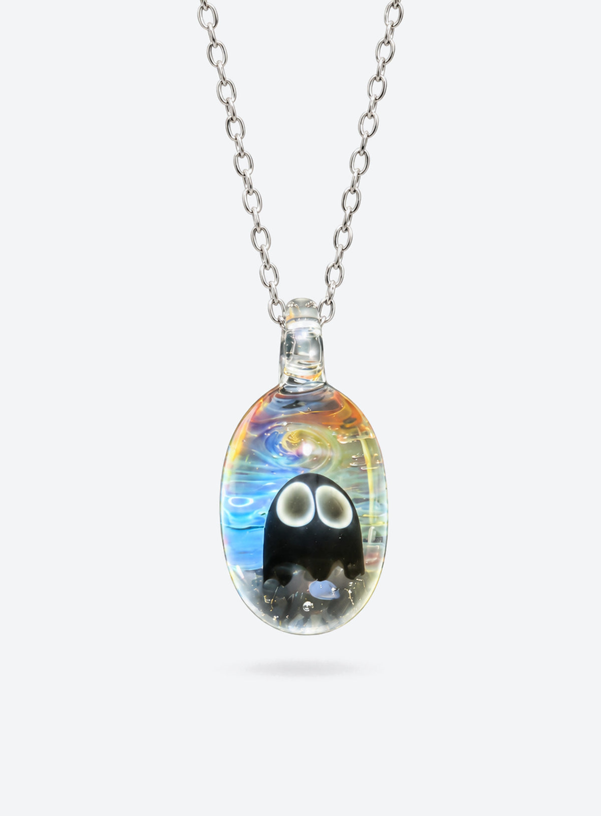 Oval clear glass pendant with a ghost, blue, white, and yellow swirls, and a silver-tone chain