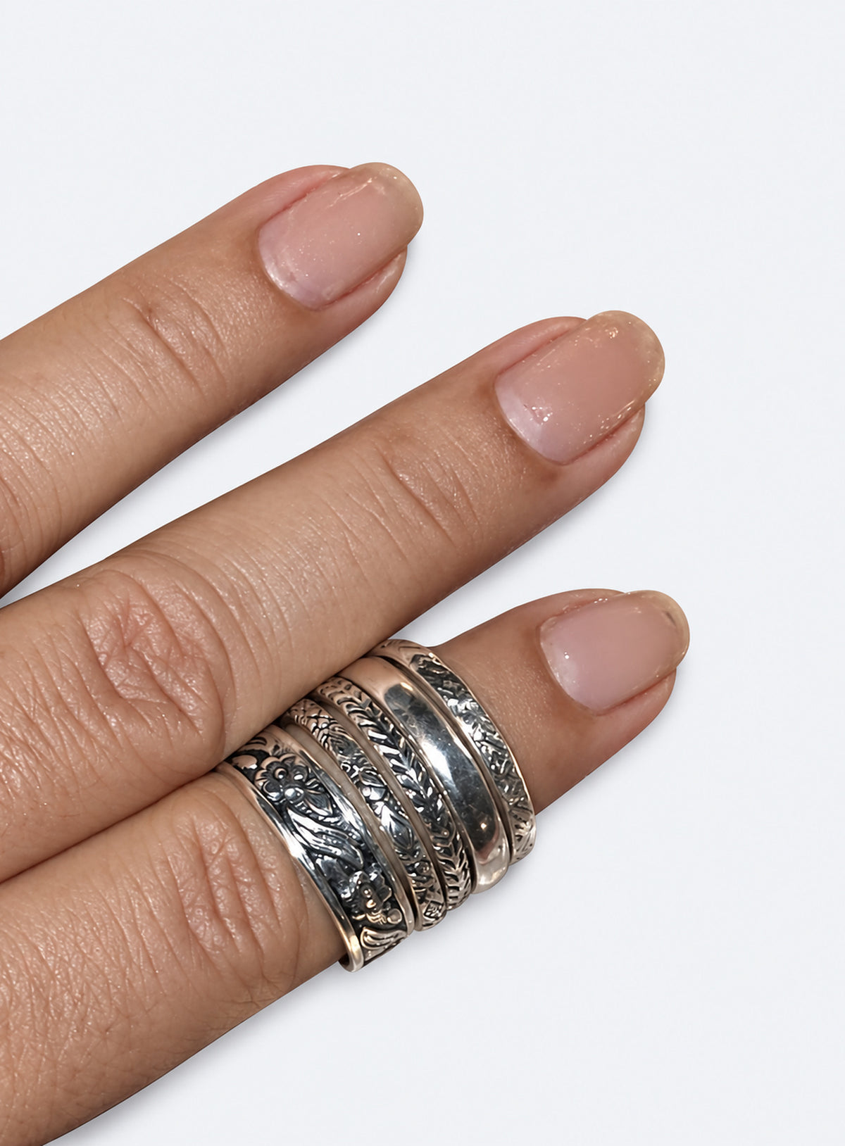 Five sterling silver floral and patterned stacking rings