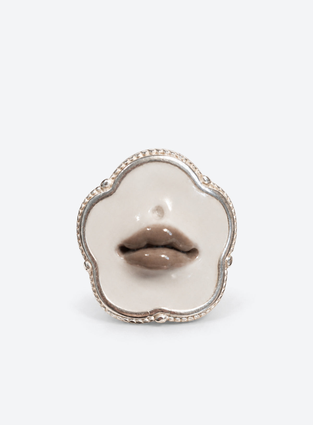 Sculpted gray lips on a white base in a silver-tone ring setting (Flower)