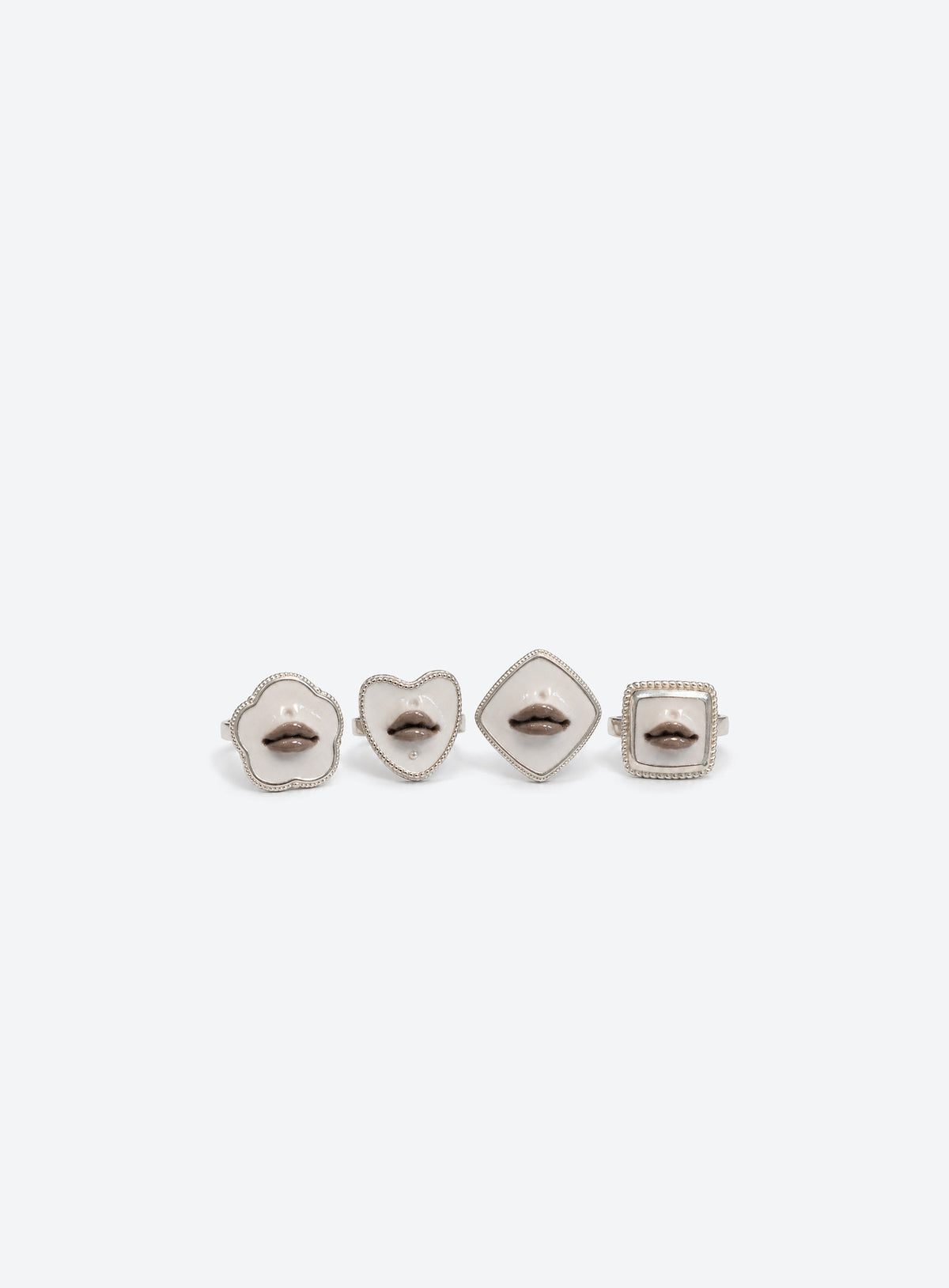 Sculpted gray lips on a white base in a silver-tone ring setting