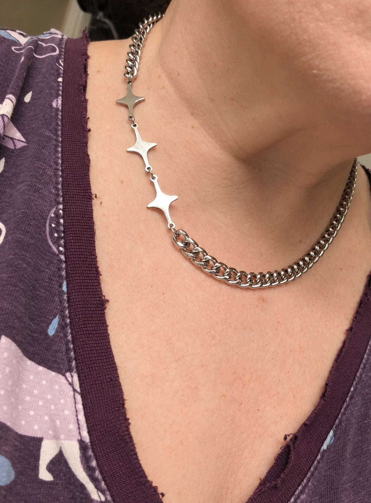 Silver-tone chain necklace with three spaced four-point starburst shapes