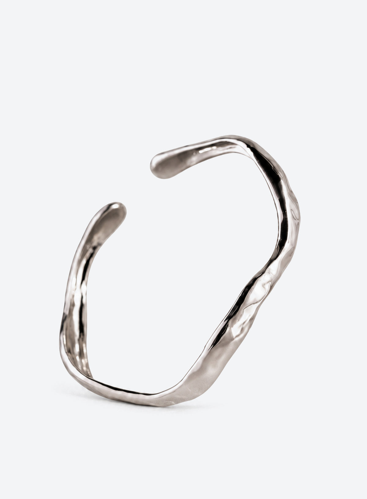Open cuff bracelet with sculpted wavy edges and a textured polished surface (Silver)