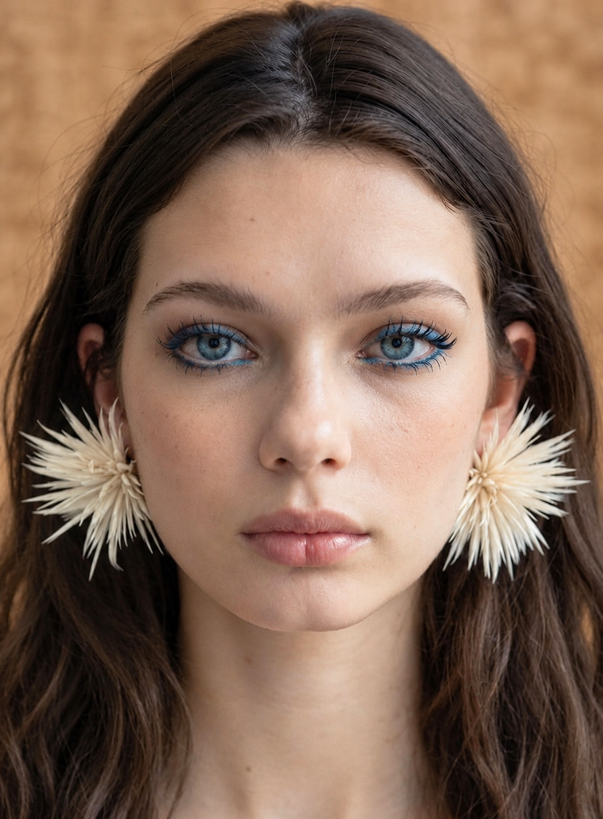 White stud earrings with natural feathers arranged into flower shapes
