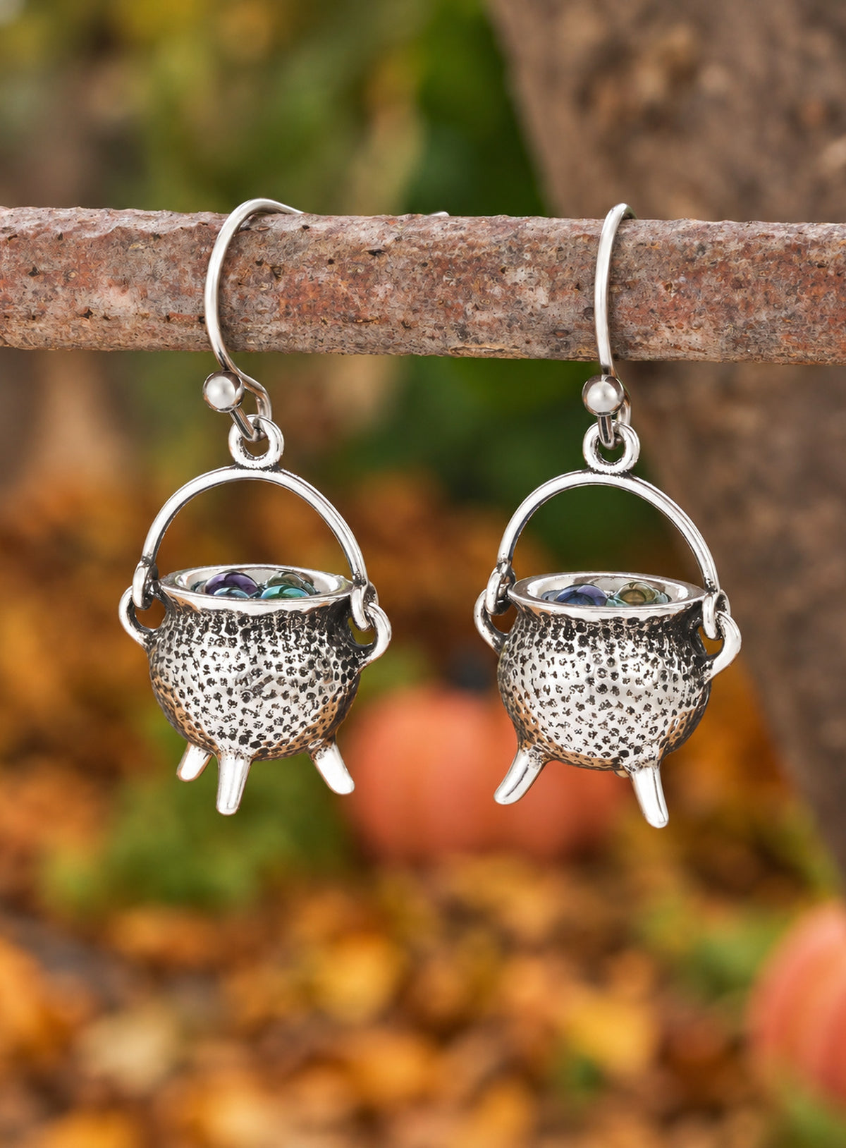 A pair of vintage silver-tone cauldron earrings with curved handles and French ear hooks