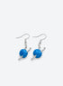 A pair of blue yarn ball earrings with silver-tone crochet hooks and French ear hooks